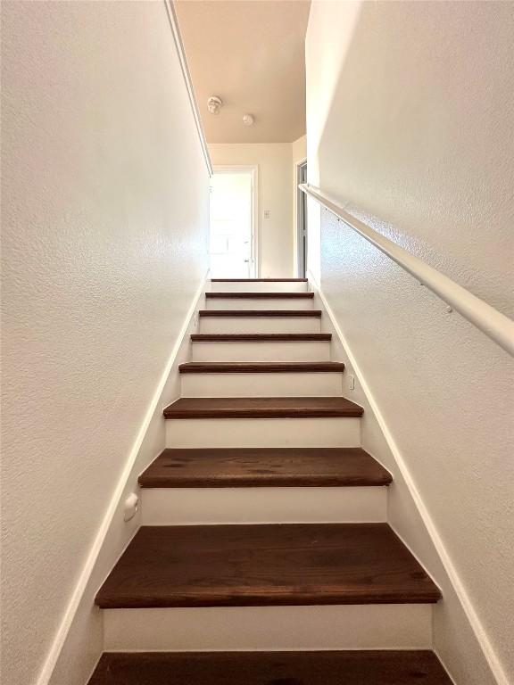 stairs with a textured wall