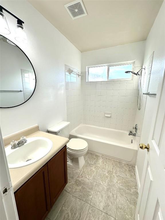 bathroom featuring toilet, shower / bathtub combination, vanity, and visible vents