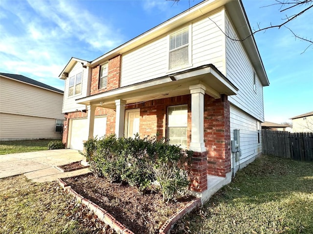 traditional-style home featuring driveway, an attached garage, fence, a porch, and brick siding