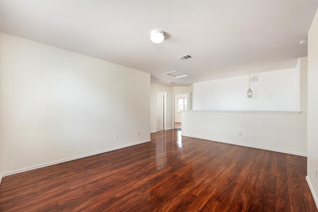13412 Forest Sage St, Manor, TX 78653 - unfurnished room featuring dark wood finished floors, attic access, and baseboards