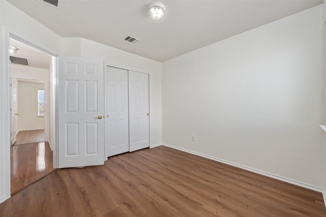 13412 Forest Sage St, Manor, TX 78653 - unfurnished bedroom with wood finished floors, baseboards, and a closet