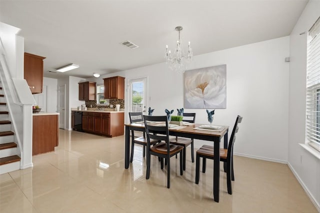 13412 Forest Sage St, Manor, TX 78653 - dining space featuring stairs, a chandelier, light tile patterned floors, and baseboards