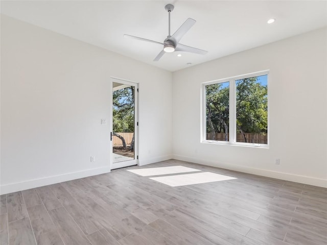 spare room featuring ceiling fan, recessed lighting, light wood-style flooring, and baseboards