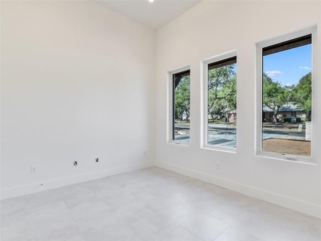 spare room with baseboards