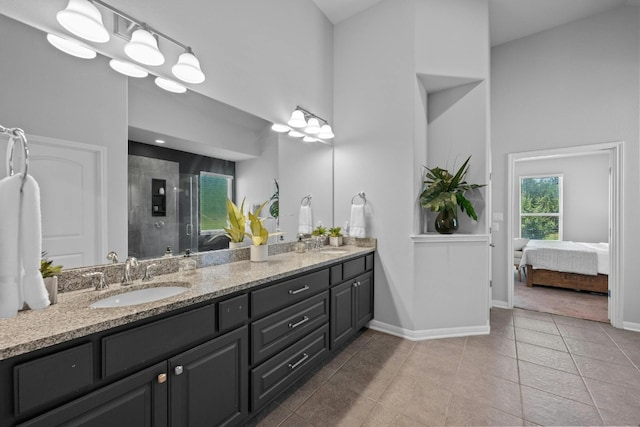 156 Mary Elise Way, Austin, TX 78737 - full bath with double vanity, a towering ceiling, a stall shower, ensuite bath, and tile patterned flooring