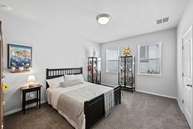 carpeted bedroom featuring visible vents and baseboards