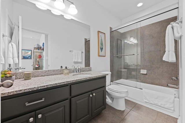 full bathroom with toilet, tile patterned flooring, combined bath / shower with glass door, and vanity