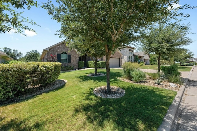 156 Mary Elise Way, Austin, TX 78737 - view of front of house with a front lawn, brick siding, an attached garage, and driveway