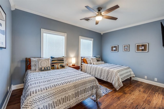 bedroom with ceiling fan, crown molding, baseboards, and wood finished floors