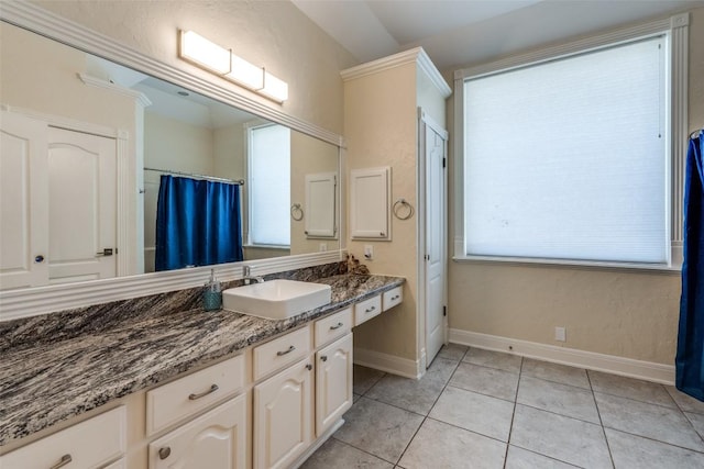 full bathroom featuring tile patterned flooring, vanity, and baseboards