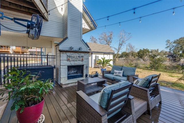 wooden deck featuring fence and an outdoor living space with a fireplace