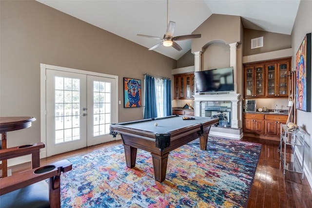 recreation room with a fireplace with raised hearth, high vaulted ceiling, visible vents, french doors, and dark wood finished floors
