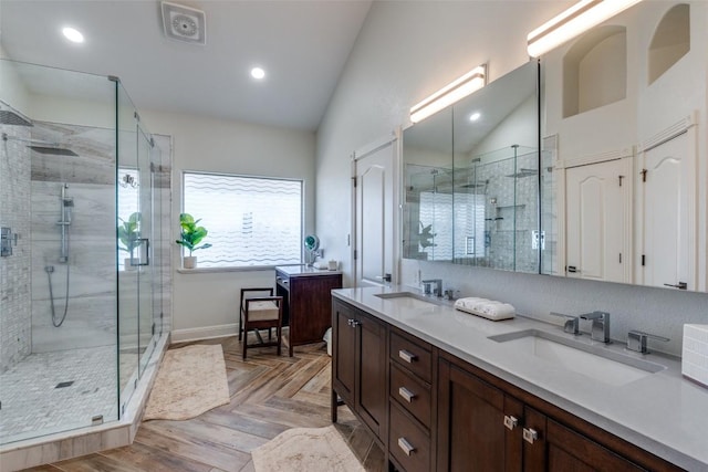 bathroom featuring double vanity, vaulted ceiling, and a sink