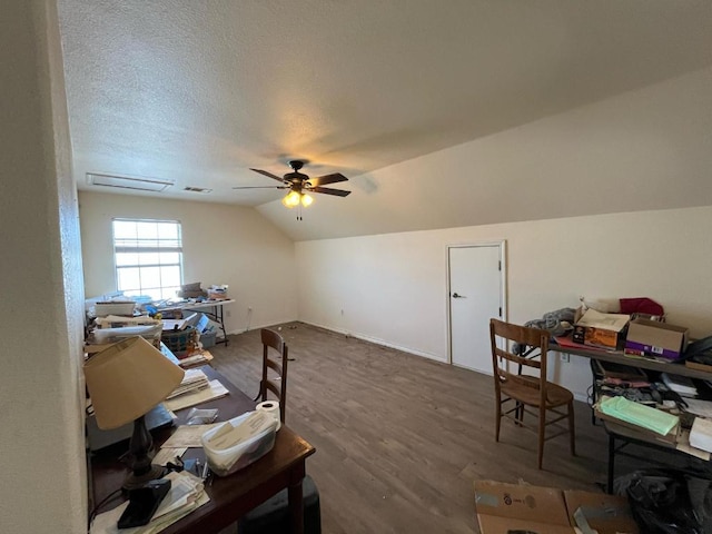 office with visible vents, ceiling fan, vaulted ceiling, a textured ceiling, and wood finished floors