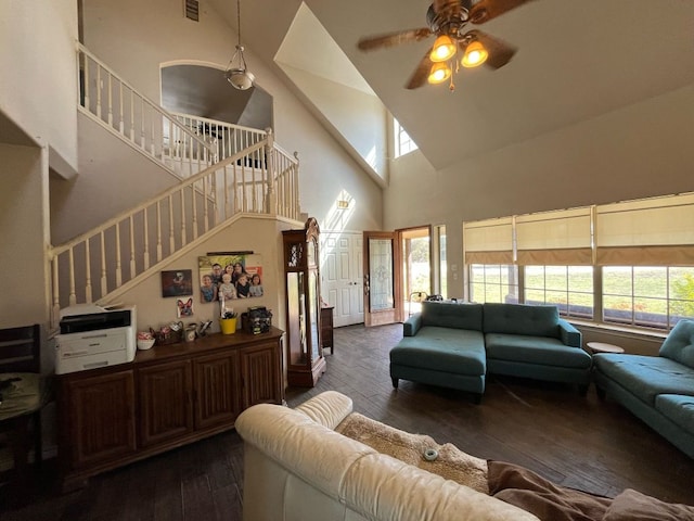 living area with stairway, hardwood / wood-style flooring, and a ceiling fan