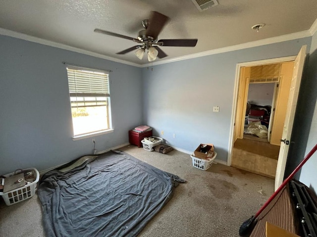 carpeted bedroom featuring crown molding, visible vents, a ceiling fan, a textured ceiling, and baseboards