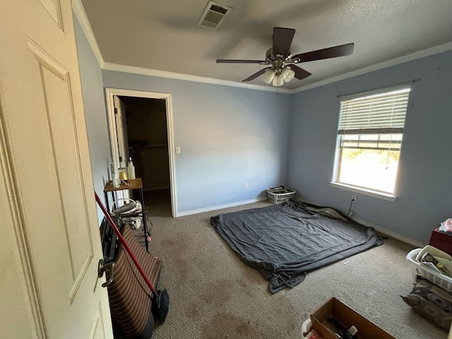 bedroom featuring baseboards, carpet floors, visible vents, and crown molding