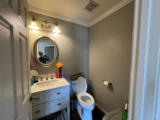 bathroom featuring ornamental molding, visible vents, vanity, and toilet