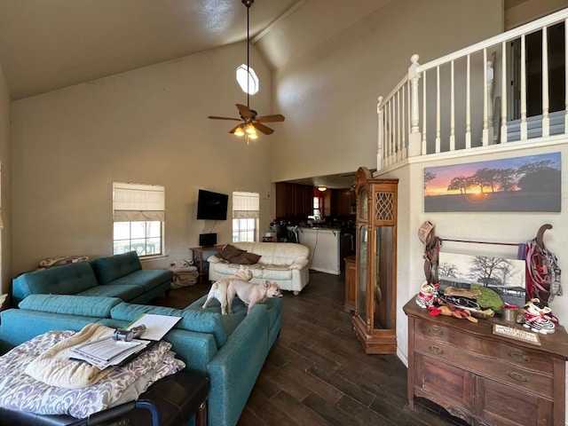 living room with dark wood-style floors, high vaulted ceiling, and a ceiling fan