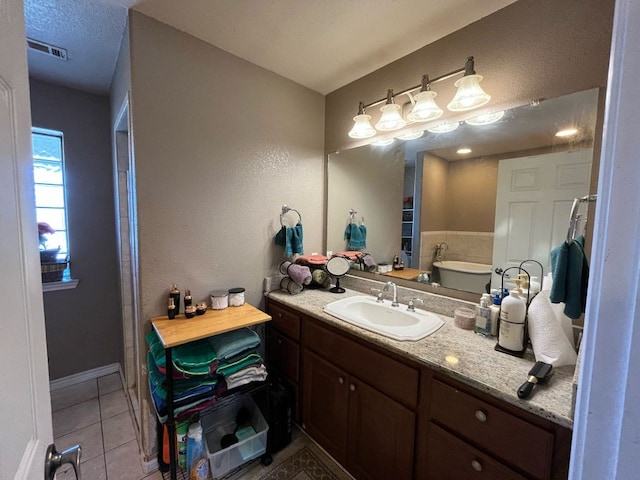 bathroom with tile patterned flooring, visible vents, and vanity