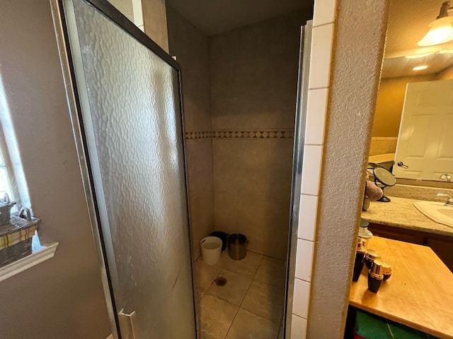 bathroom with a shower stall and vanity