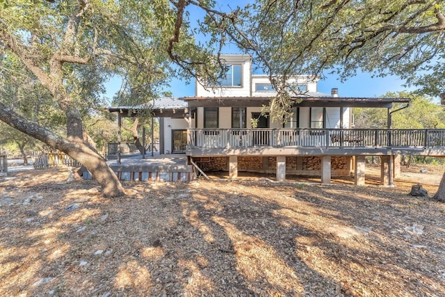 back of house with a wooden deck