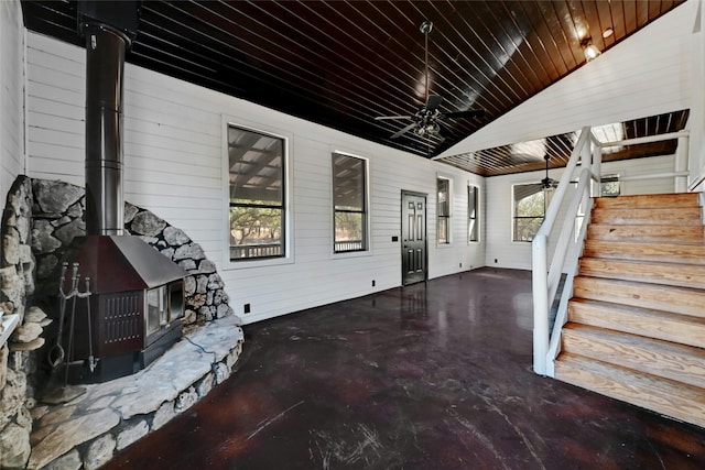 view of patio with ceiling fan and stairs