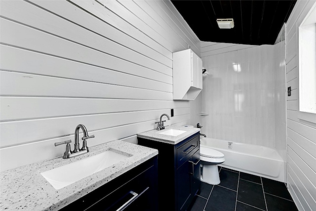 bathroom featuring tile patterned flooring, two vanities, a sink, and toilet