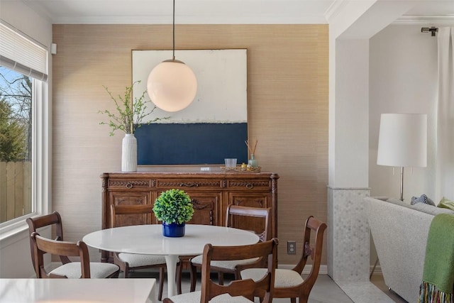 dining room with light tile patterned flooring, wallpapered walls, and crown molding