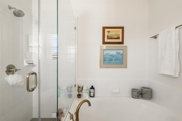 bathroom with a garden tub and a shower stall