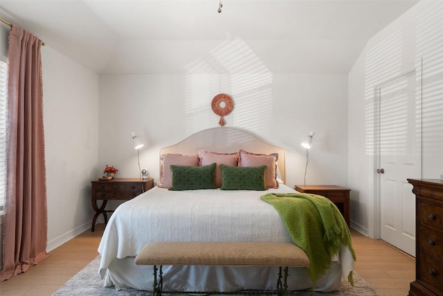 bedroom featuring baseboards and light wood finished floors