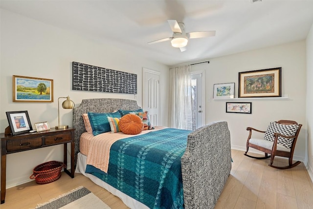 bedroom with baseboards, access to outside, light wood-style floors, and a ceiling fan