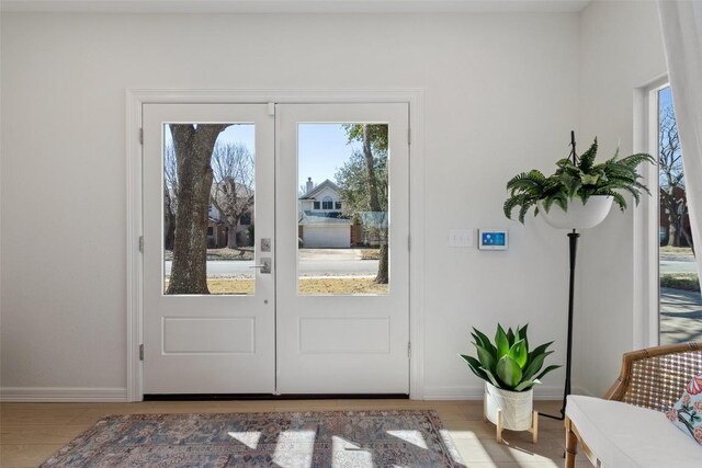 doorway featuring baseboards and french doors