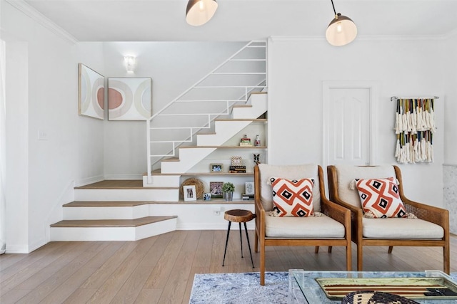 sitting room featuring baseboards, crown molding, stairway, and hardwood / wood-style floors