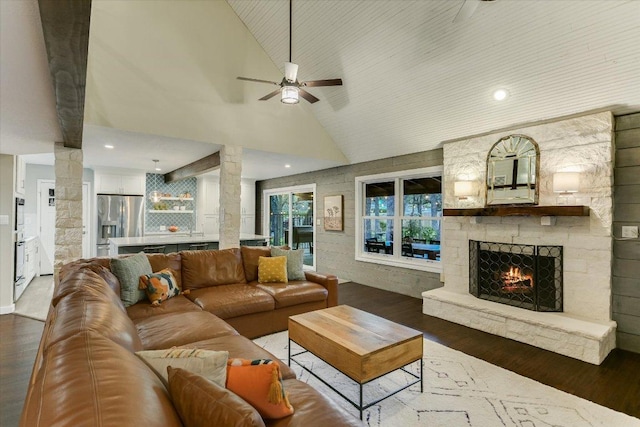 living room with a fireplace, recessed lighting, ceiling fan, wood finished floors, and high vaulted ceiling