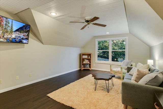 interior space featuring vaulted ceiling, baseboards, dark wood finished floors, and a ceiling fan