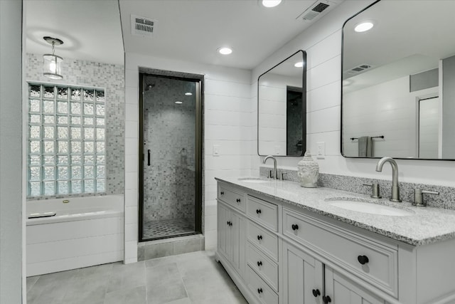full bath with a shower stall, visible vents, and a sink