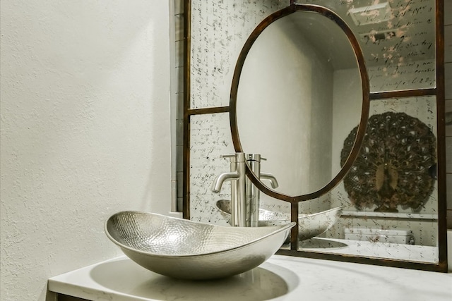 room details with a textured wall and a sink