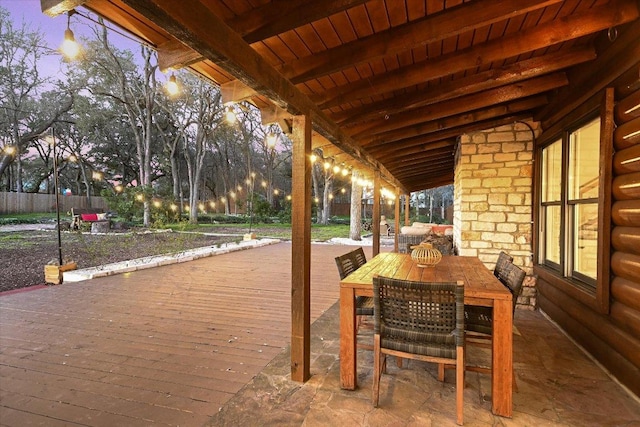 view of patio featuring outdoor dining space and fence