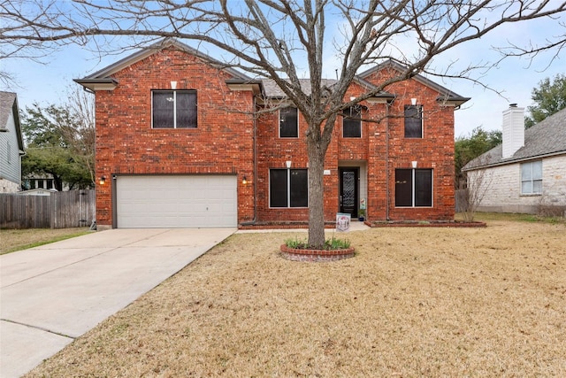 traditional home with brick siding, concrete driveway, a front yard, fence, and a garage