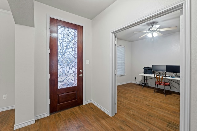 foyer featuring ceiling fan, wood finished floors, and baseboards