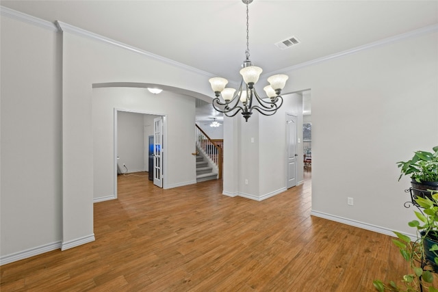 unfurnished dining area with light wood-style floors, visible vents, and ornamental molding