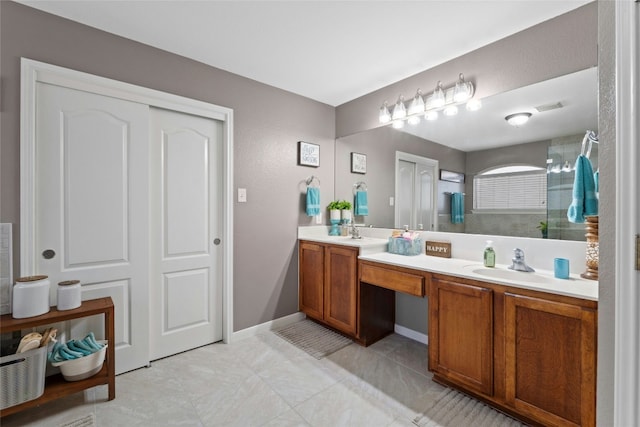 bathroom featuring double vanity, a sink, visible vents, and baseboards