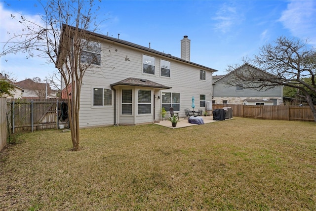 back of property featuring a patio area, a fenced backyard, a yard, and a chimney