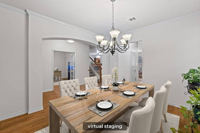 1532 Homewood Cir, Round Rock, TX 78665 - dining space with a chandelier, arched walkways, stairway, crown molding, and baseboards