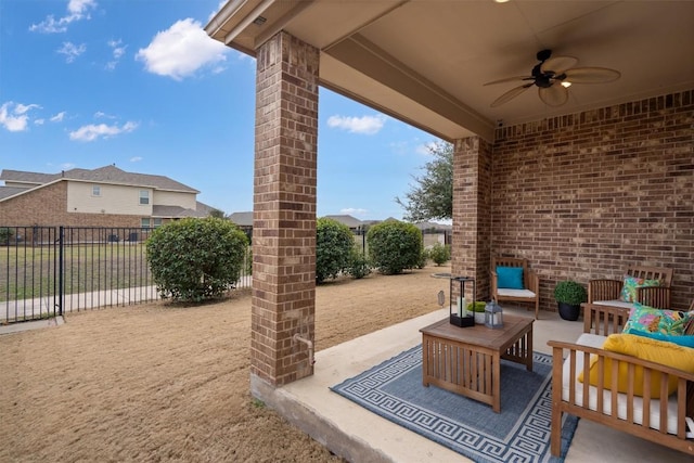 view of patio with outdoor lounge area, fence, and a ceiling fan