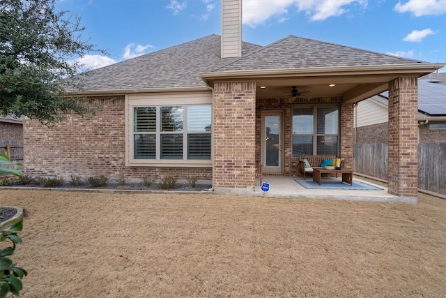 rear view of house featuring a patio area, fence, a ceiling fan, and brick siding