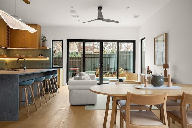 interior space with ceiling fan, visible vents, and light wood-style floors