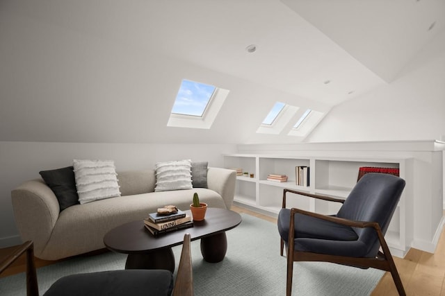 sitting room featuring light wood-type flooring and vaulted ceiling