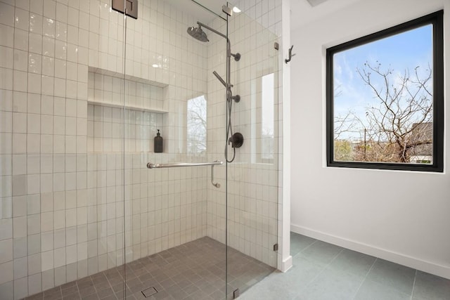 bathroom featuring a stall shower, baseboards, and tile patterned floors